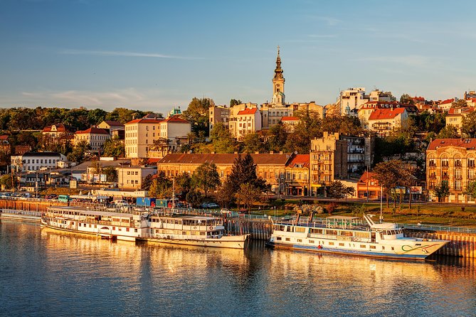 Belgrade&rsquo;s old town above the Sava riverboats at golden hour